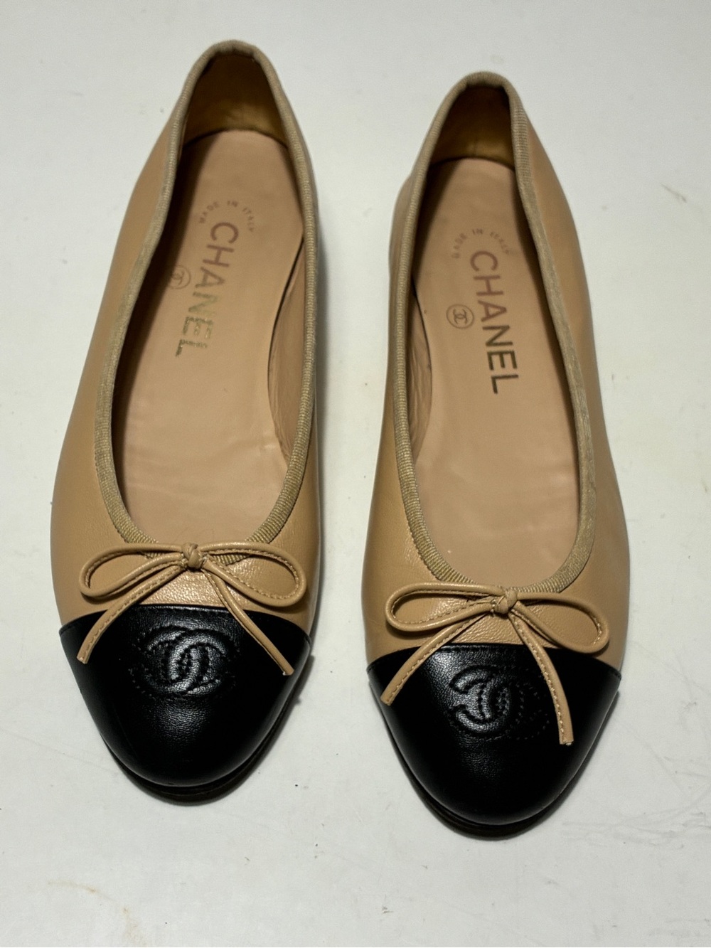 CHANEL Beige Leather Ballet Flats with Black Cap Toe and Bow